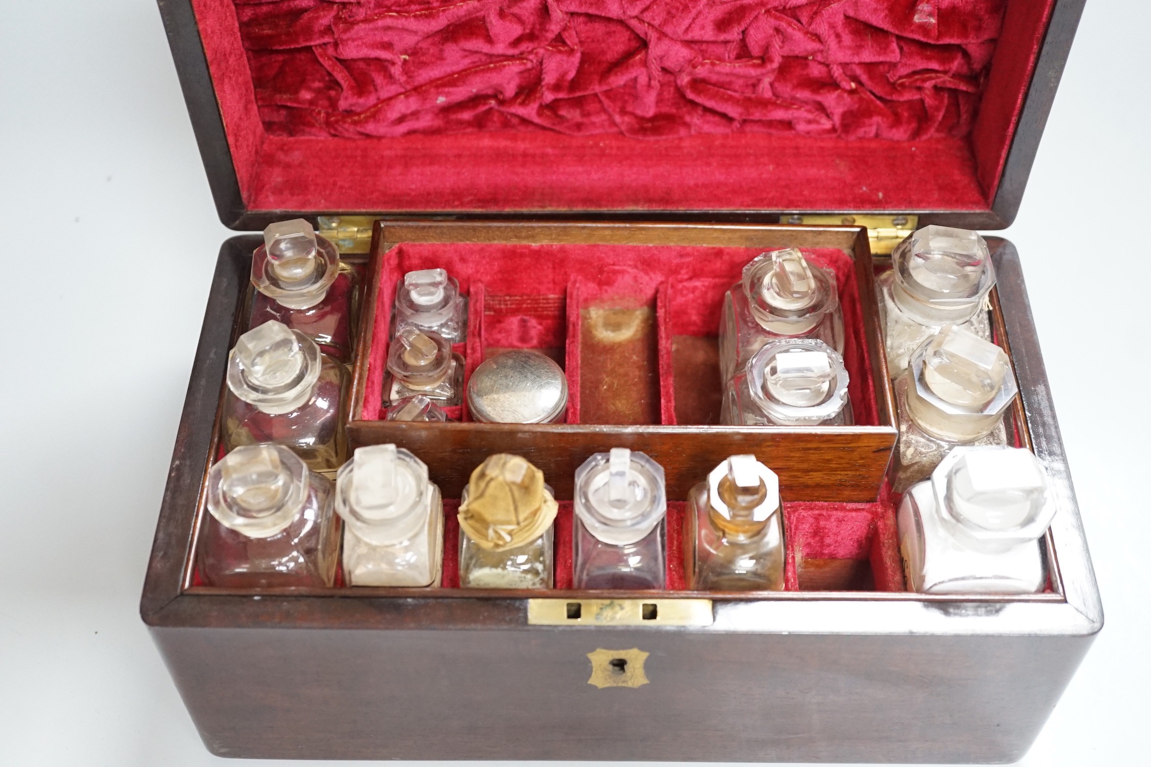 A 19th century mahogany cased travelling apothecary set with glass flasks, handle plate engraved ‘Dr.Tulk’, 26cm wide